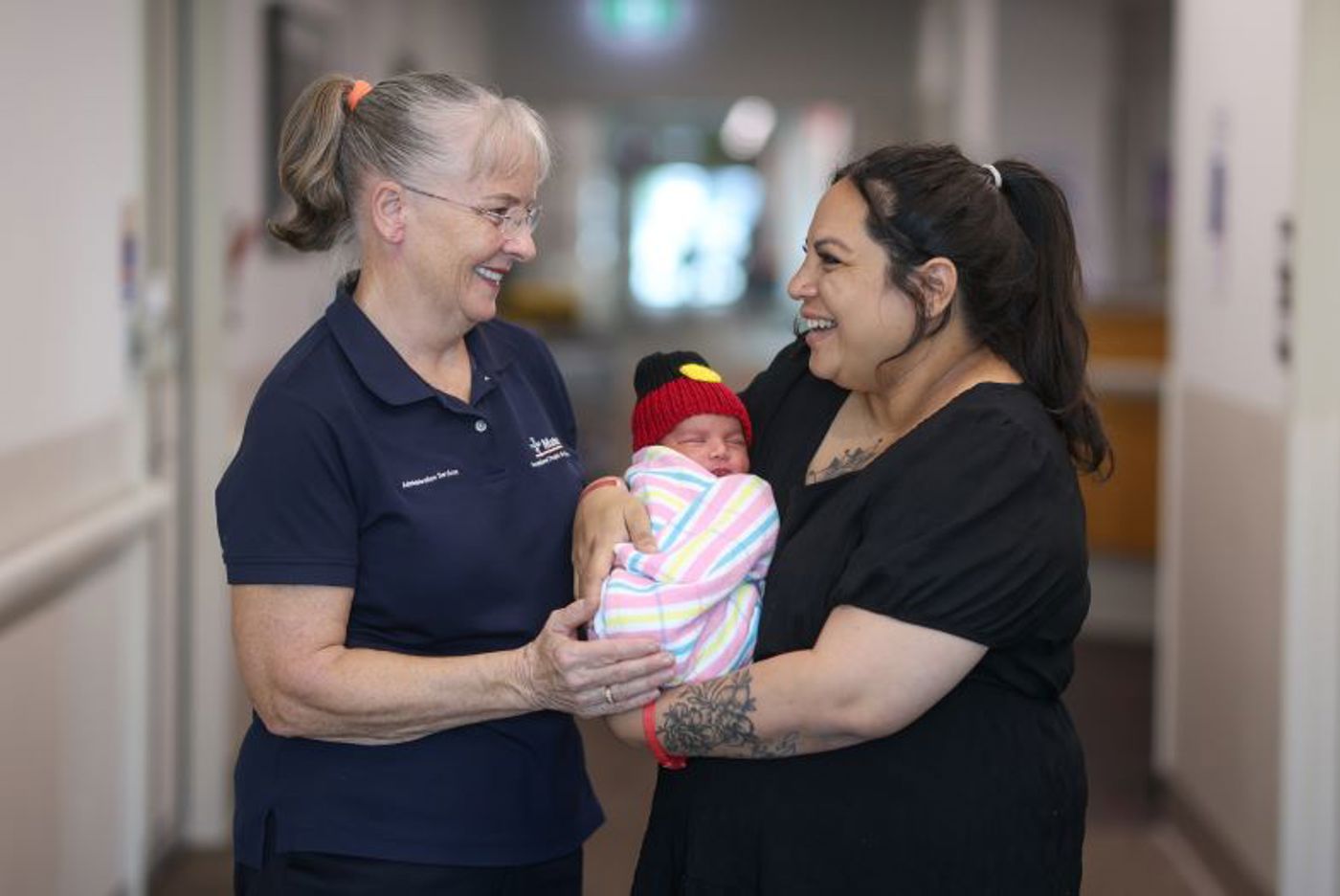 Mater at Home employee Theresa Fox with baby Djalu Milligan and his mother, Emily Mallie.