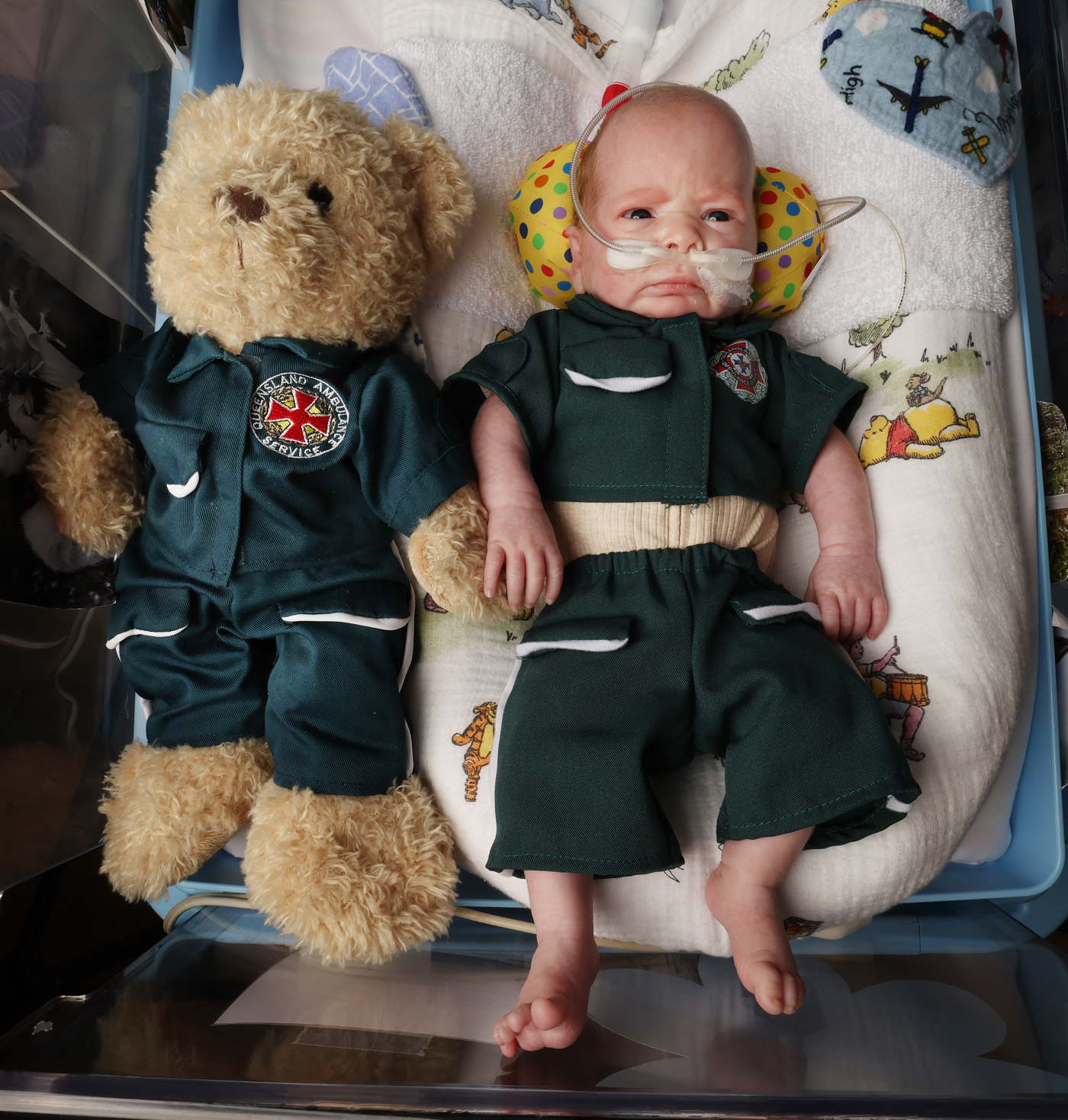 Baby Reid is tiny enough to fit into the same outfit as his QAS teddy.