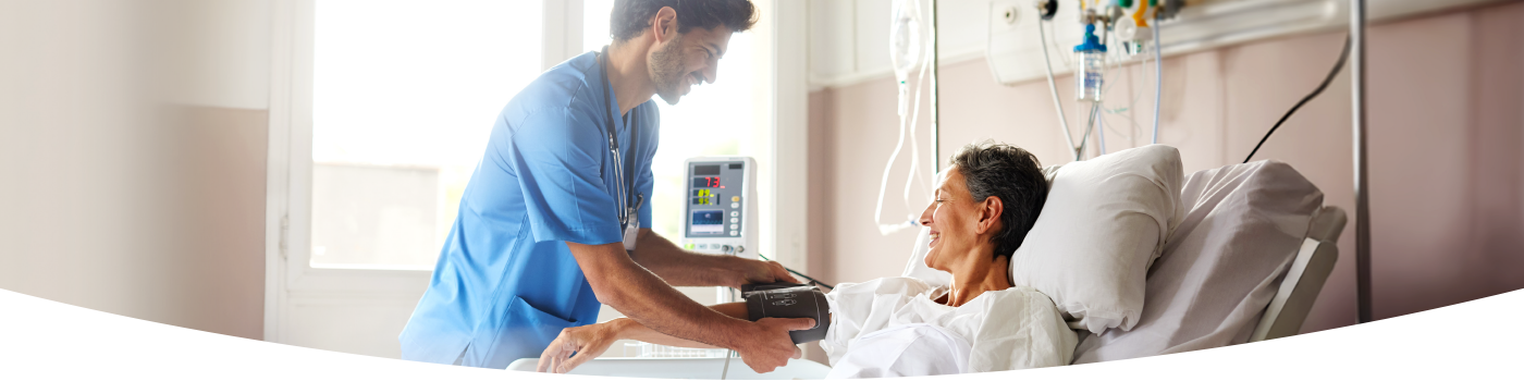 Male nurse with female patient taking blood pressure